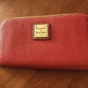 Dooney and Burke clutch/wallet. Red leather. 7x4 inches. Never used.